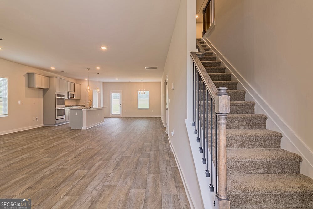 148 Post Oak Drive, Unit 139 Jackson, GA 30233 - Photo 6 of 24 a view of a kitchen with wooden floor and electronic appliances