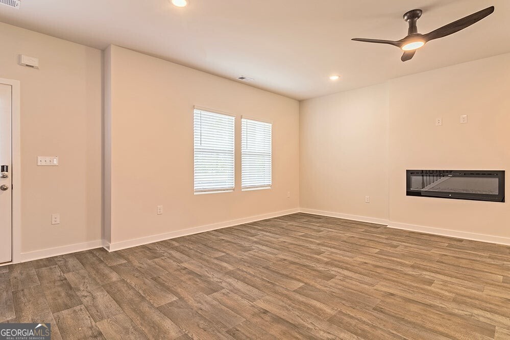 148 Post Oak Drive, Unit 139 Jackson, GA 30233 - Photo 7 of 24 a view of empty room with wooden floor and fan