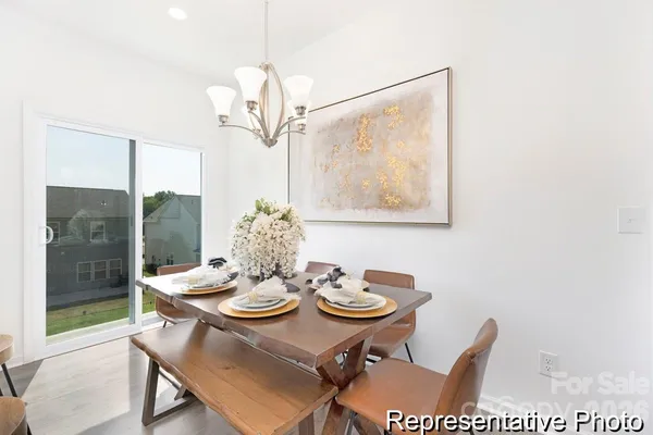 a view of a dining room with furniture wooden floor and a chandelier