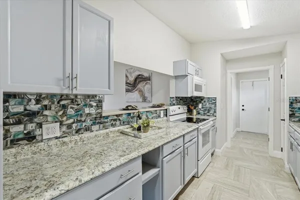 a kitchen with a sink stove and cabinets