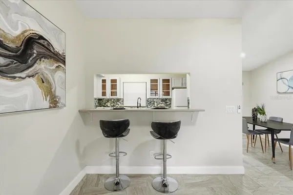 a dining room with furniture and a chandelier
