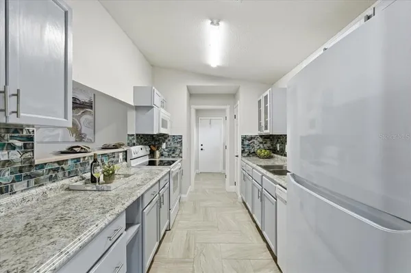 a kitchen with stainless steel appliances granite countertop lots of counter top space a sink and cabinets
