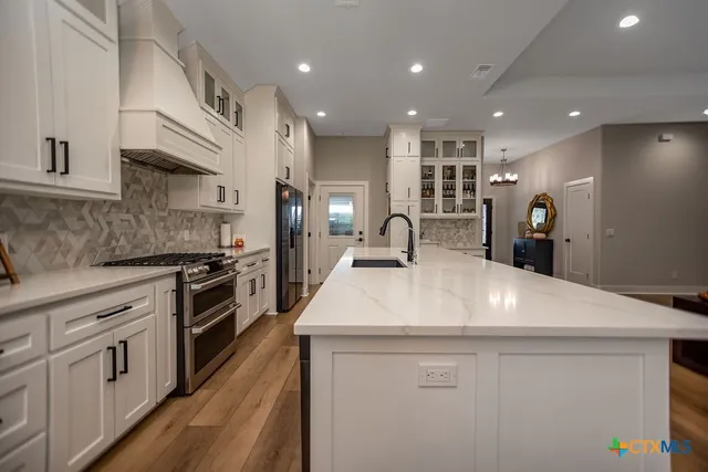 a spacious bathroom with a granite countertop sink mirror and a shower