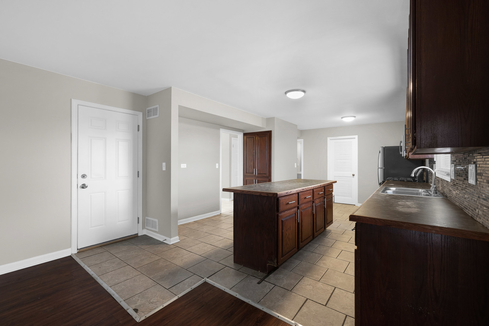 3497 Ronald Road Crete, IL 60417 - Photo 2 of 17 a large kitchen with kitchen island granite countertop a sink and dishwasher a stove with wooden floor