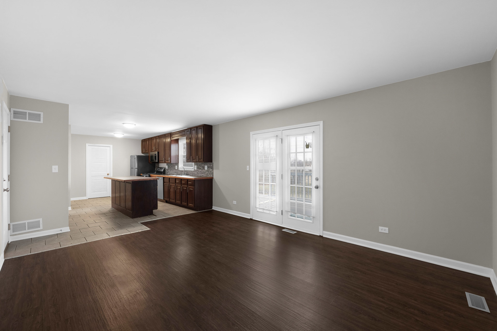 3497 Ronald Road Crete, IL 60417 - Photo 3 of 17 a view of a kitchen with wooden floor and a window