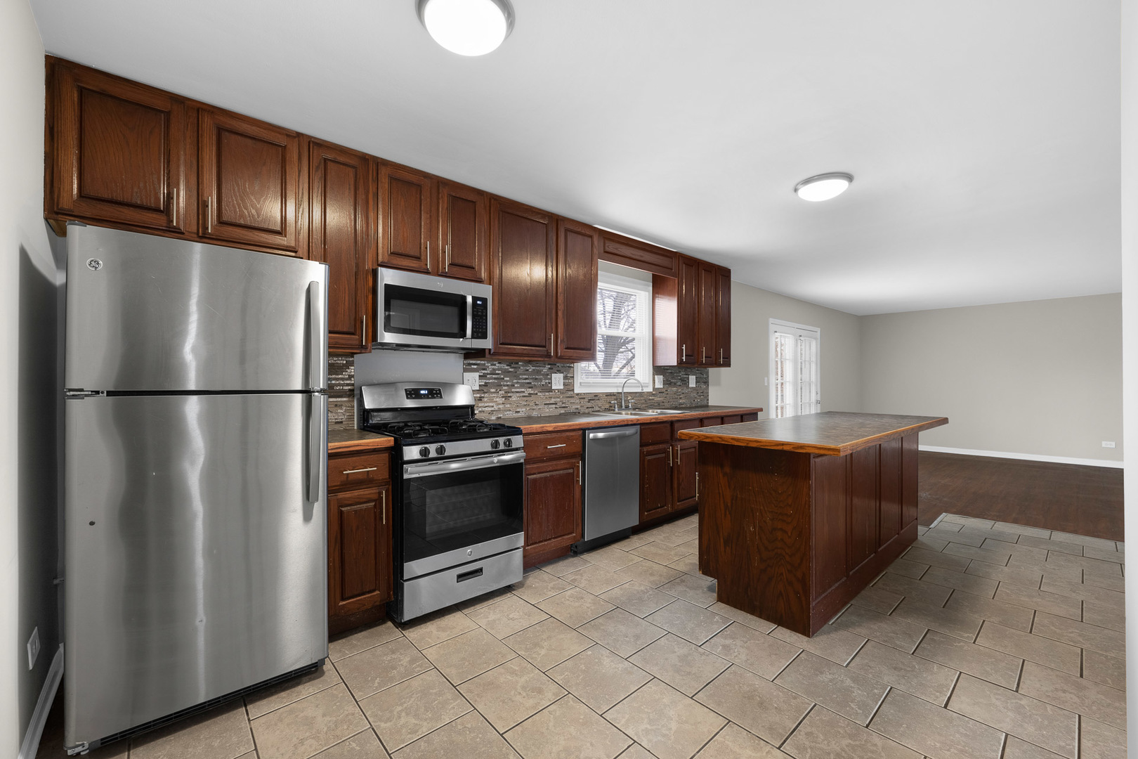 3497 Ronald Road Crete, IL 60417 - Photo 4 of 17 a kitchen with stainless steel appliances granite countertop a refrigerator a stove a sink and a refrigerator