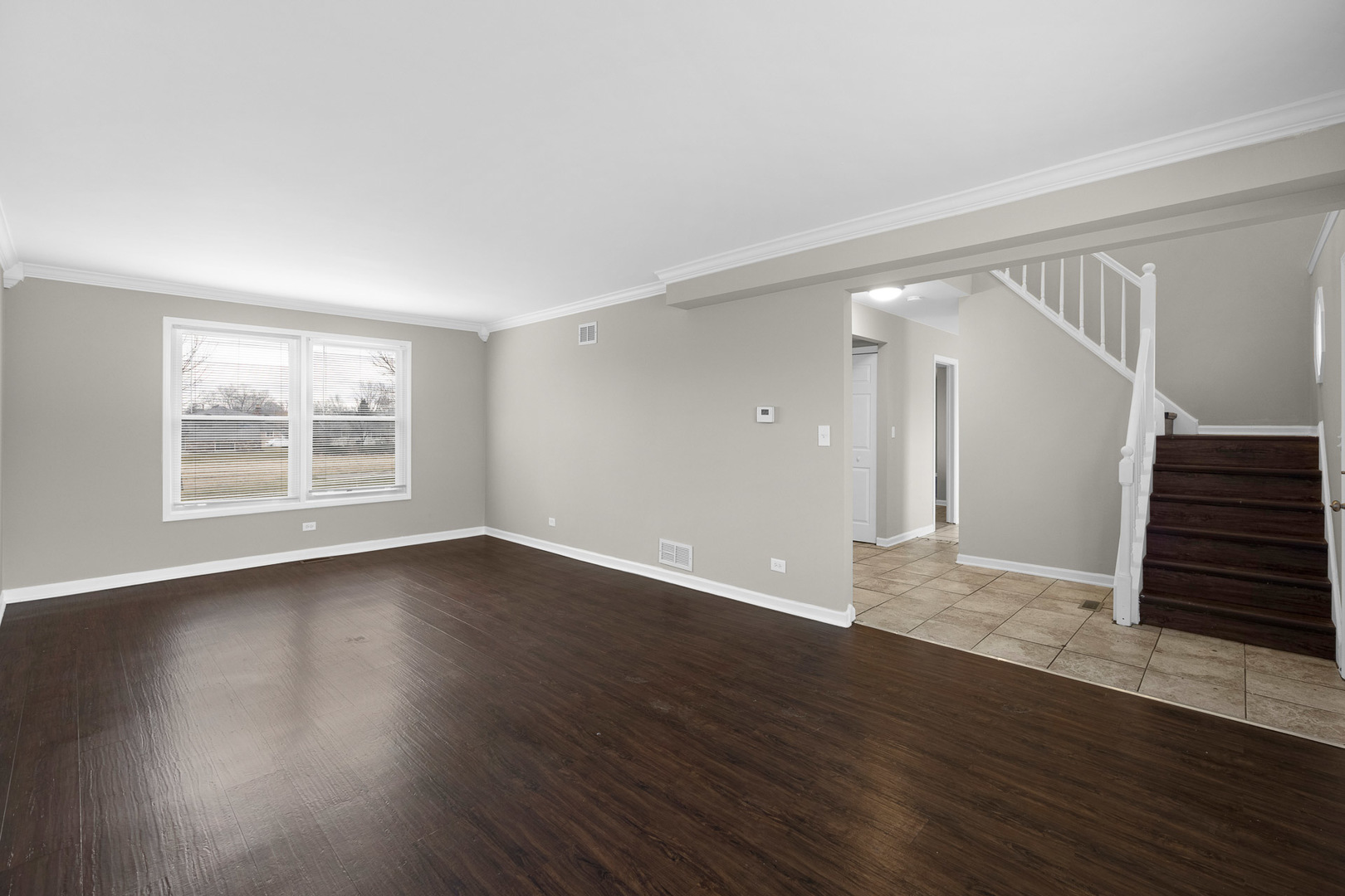 3497 Ronald Road Crete, IL 60417 - Photo 5 of 17 a view of an empty room with wooden floor and a window