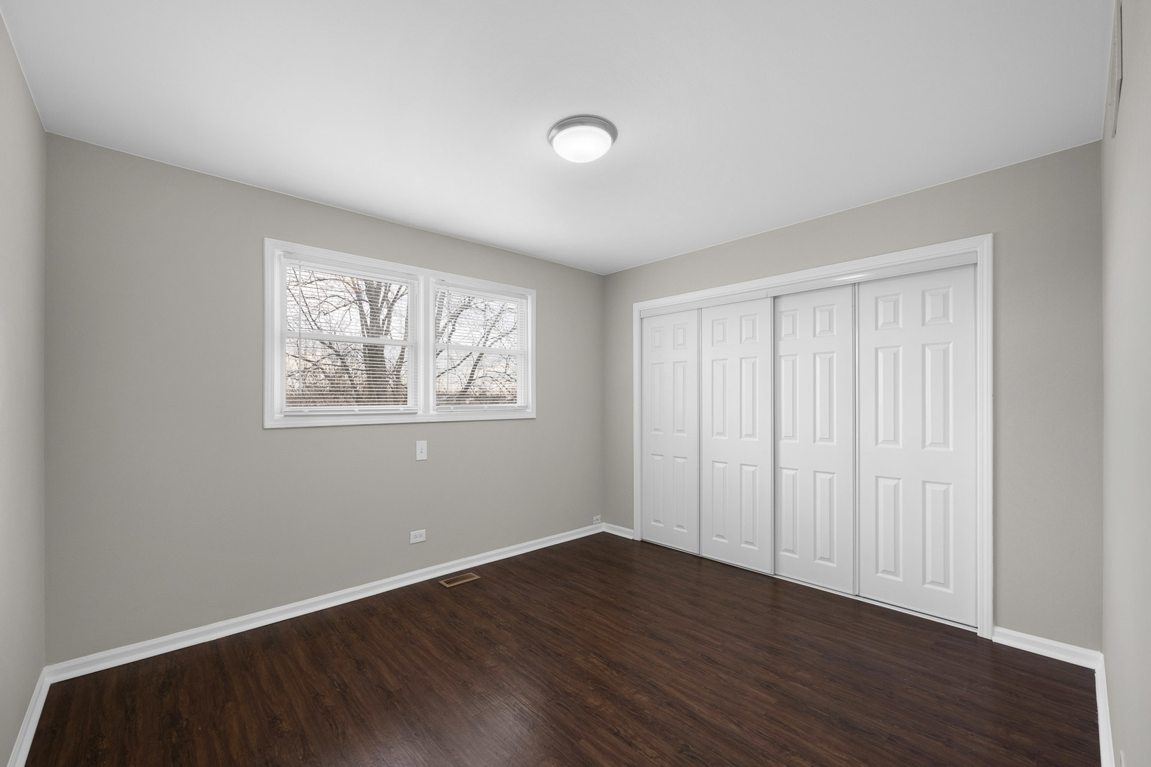 3497 Ronald Road Crete, IL 60417 - Photo 6 of 17 a view of an empty room with wooden floor and a window