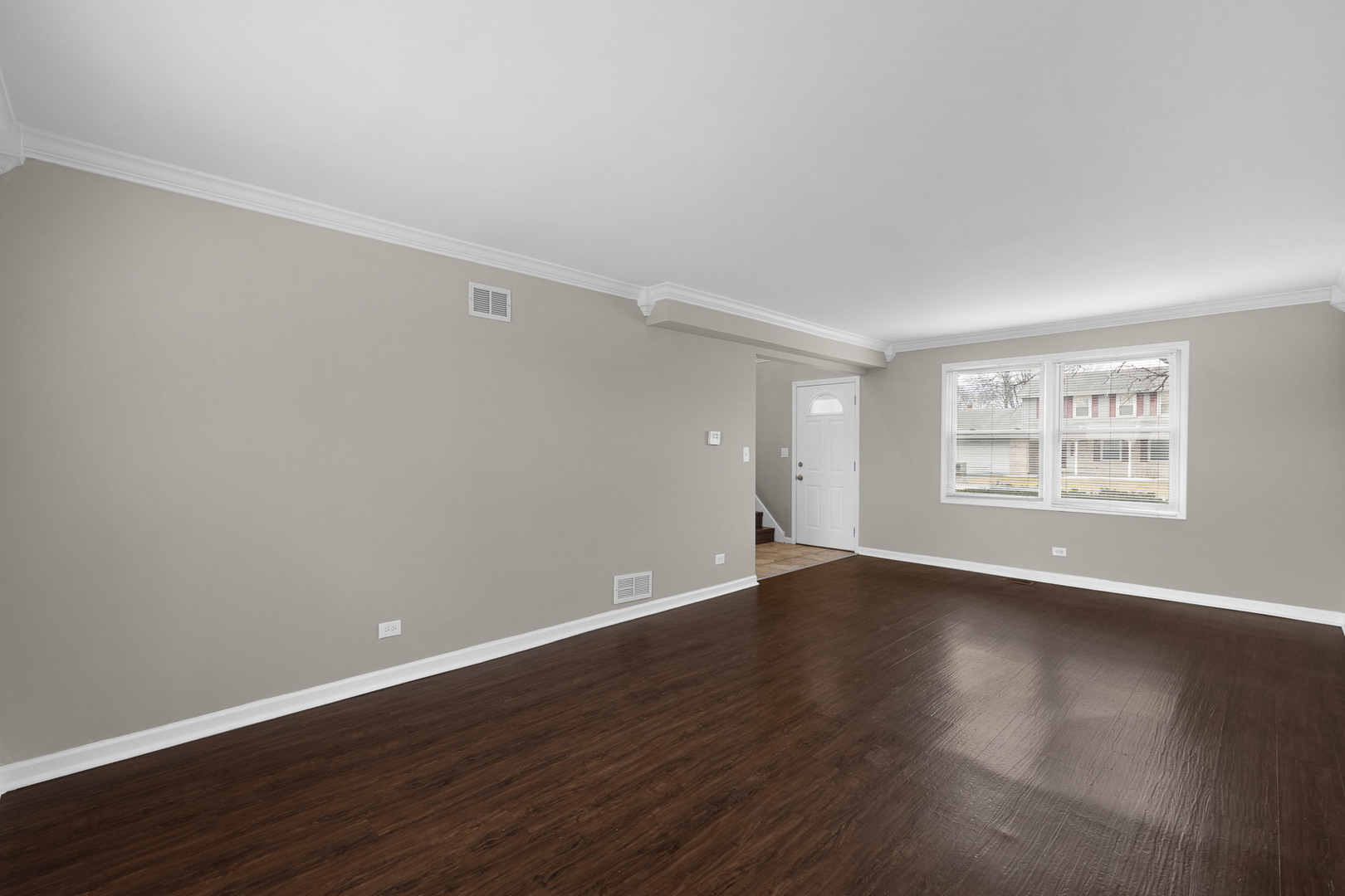 3497 Ronald Road Crete, IL 60417 - Photo 9 of 17 a view of an empty room with wooden floor and a window