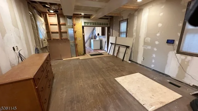 a view of a kitchen with fridge and front door