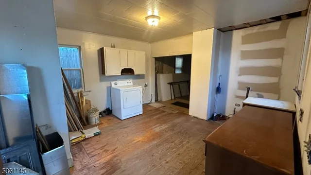 a view of kitchen with refrigerator stove and wooden floor