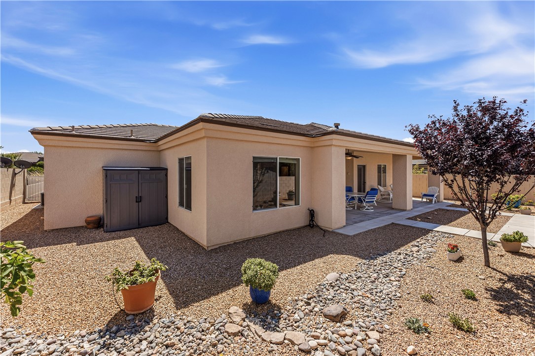 3315 Rainbow Mine Road Kingman, AZ 86401 - Photo 49 of 54 The property features a private patio area, an exterior storage shed, and a low-maintenance gravel yard with decorative rock landscaping