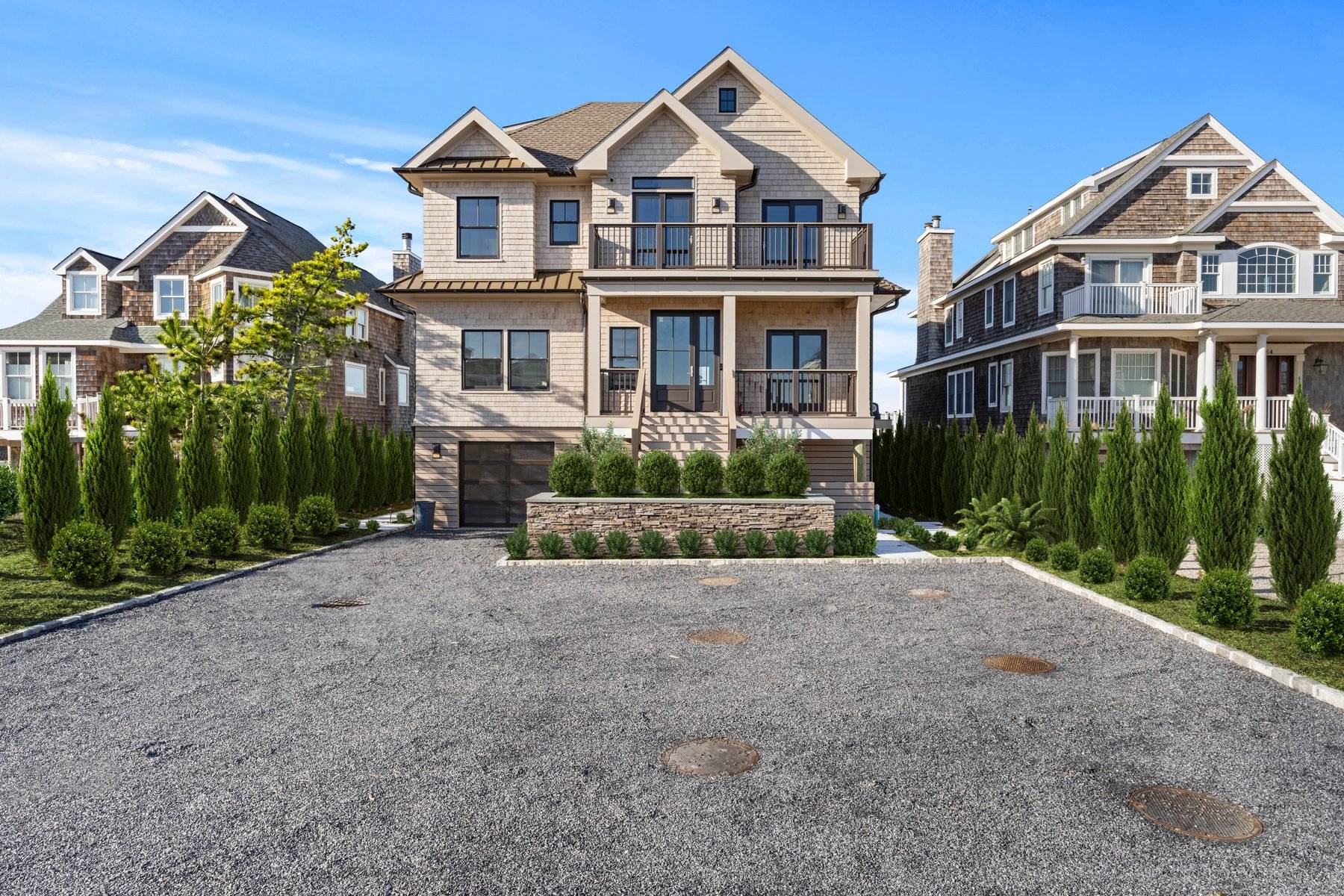 686 Dune Road Westhampton Beach, NY 11978 - Photo 3 of 37 a front view of a house with a garden