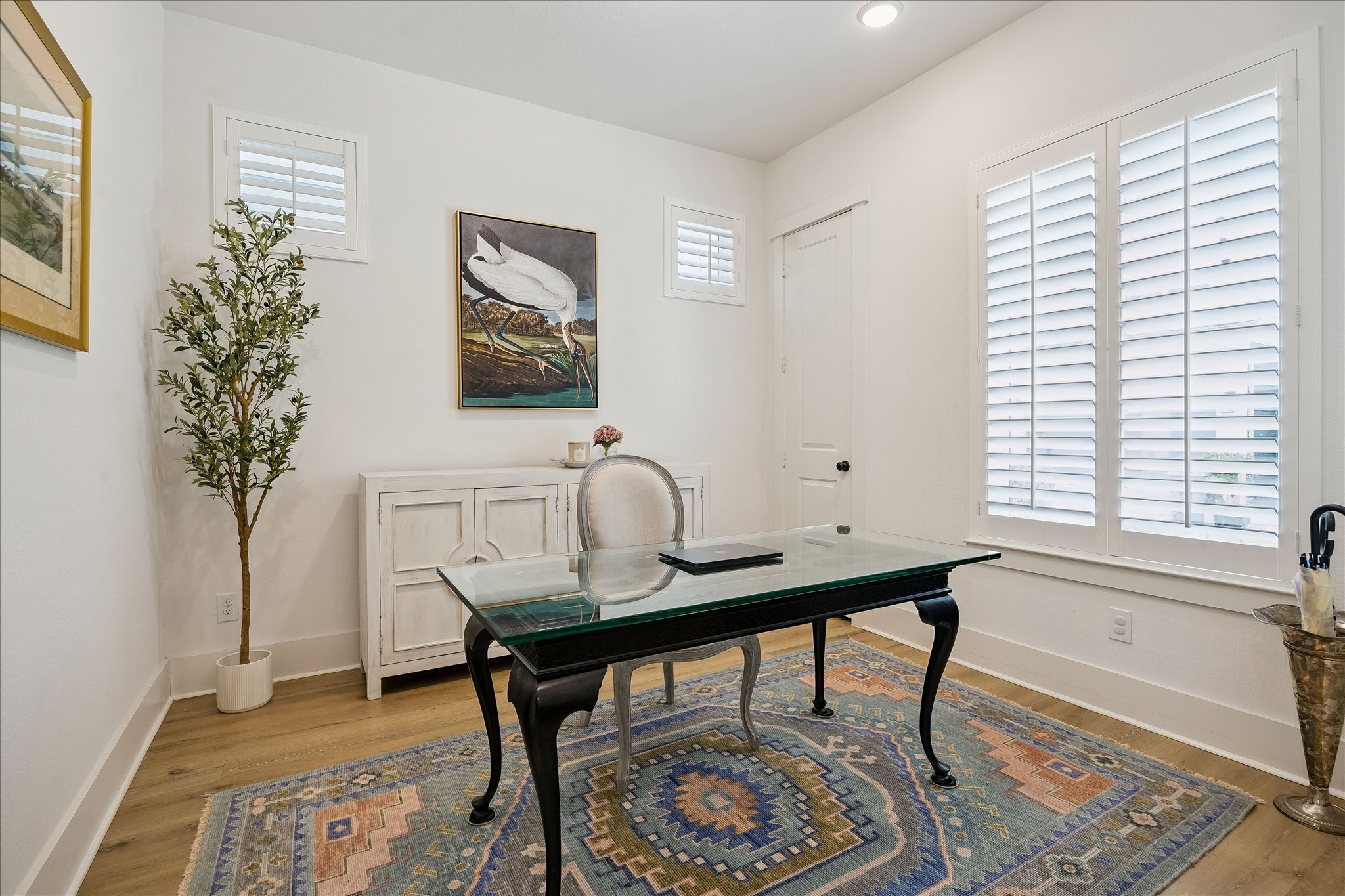 2512 Swang Pl. Houston, TX 77008 - Photo 4 of 46 This spacious home office with natural light streaming through plantation shutters creates a sophisticated and inviting workspace.