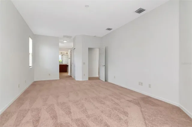 a view of an empty room with a kitchen
