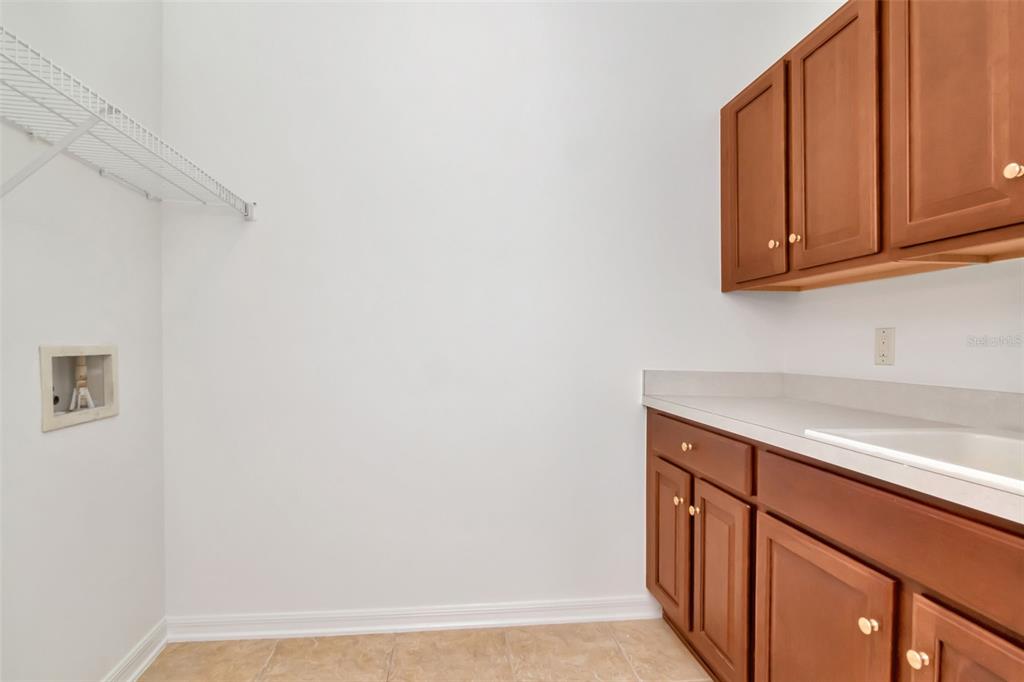 1927 Alecost Court Trinity, FL 34655 - Photo 27 of 44 a kitchen with a sink and cabinets