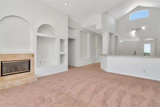 a view of a kitchen with a sink and a fireplace