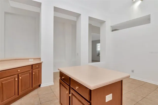 a kitchen with a wooden cabinets and white cabinets