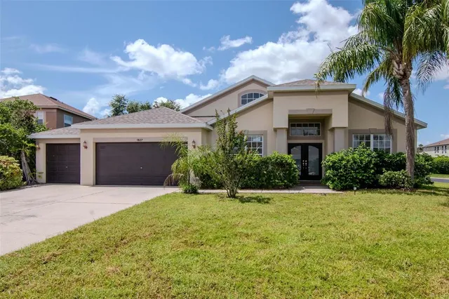 a front view of a house with a yard and garage
