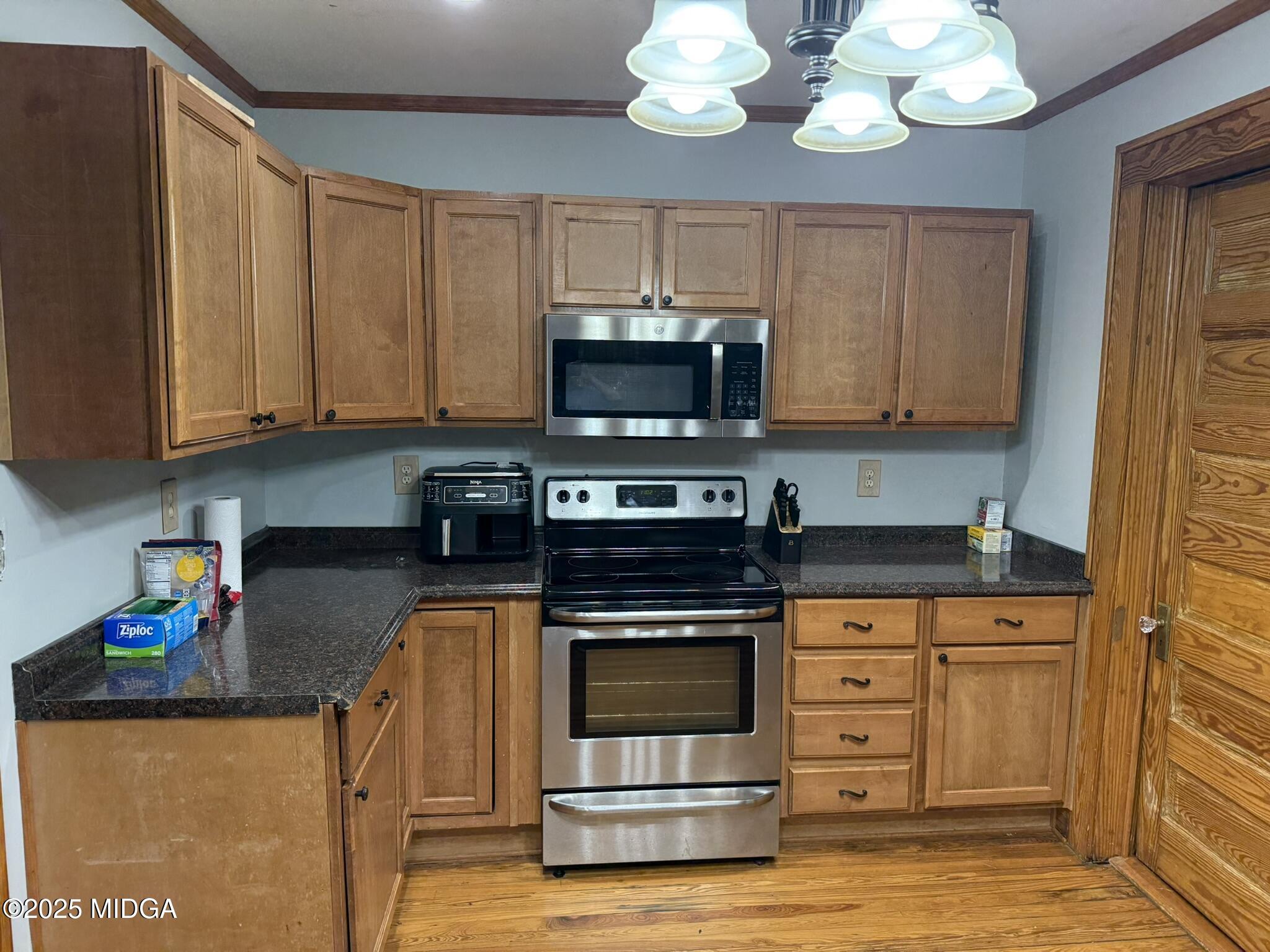 3020 Millerfield Road Macon, GA 31217 - Photo 10 of 20 a kitchen with stainless steel appliances granite countertop a stove and a microwave