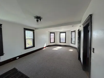 a view of a livingroom with a ceiling fan and window