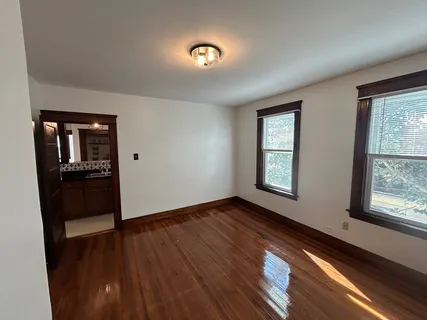a view of hallway with wooden floor