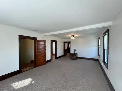a view of an empty room with windows