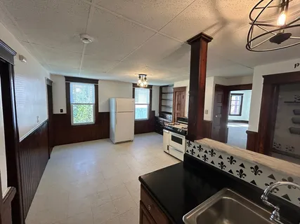 a kitchen with a refrigerator and a stove
