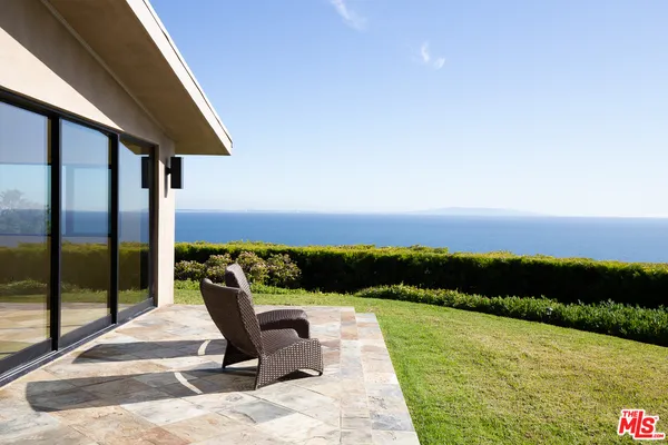 a swimming pool with outdoor seating and yard