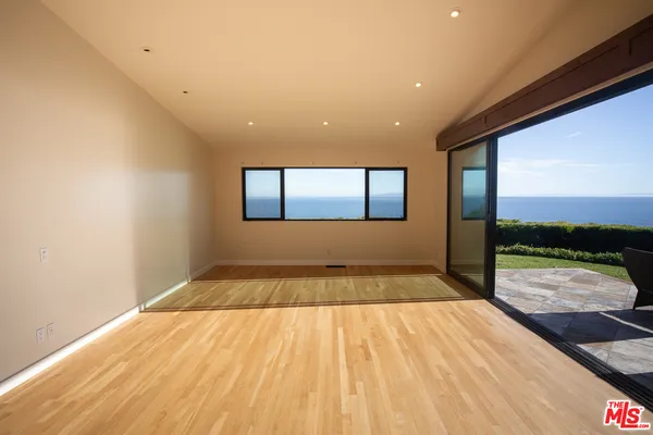 a view of a room with a floor to ceiling window and a wooden floor