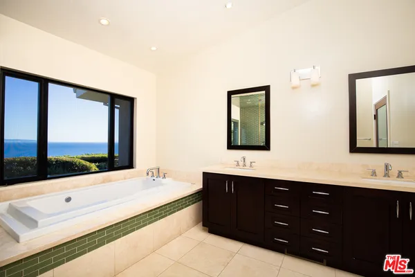 a bathroom with a double vanity sink and mirror