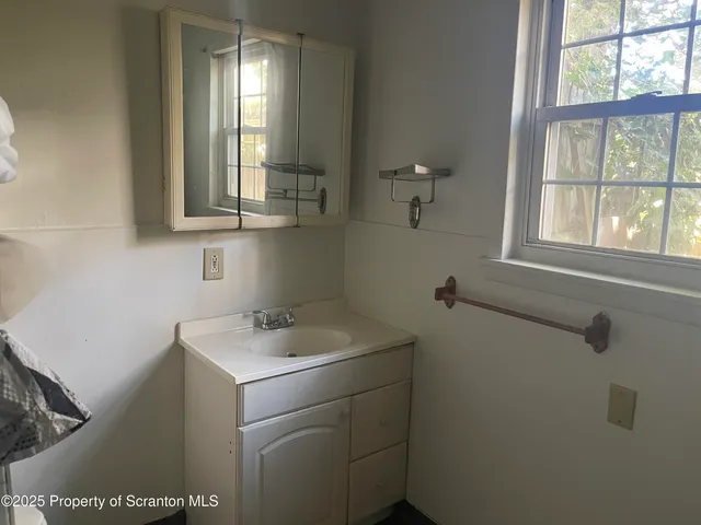 a bathroom with a sink and a window