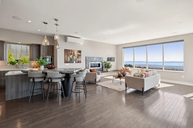 a living room with furniture large window and flat screen tv