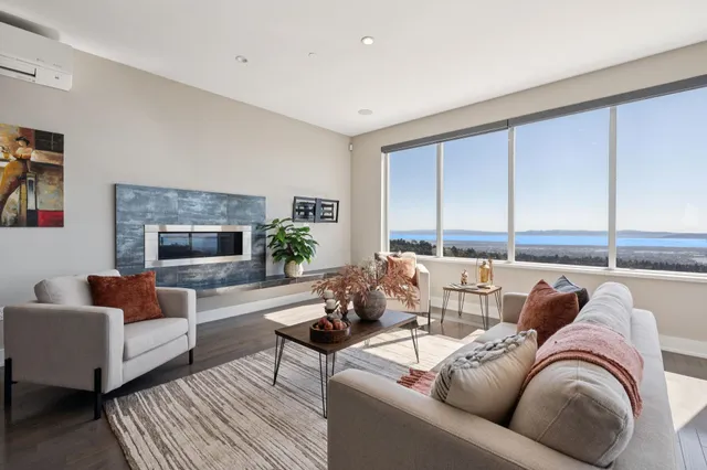 a living room with furniture and a floor to ceiling window