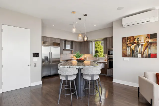 a kitchen with granite countertop kitchen island a table and chairs in it