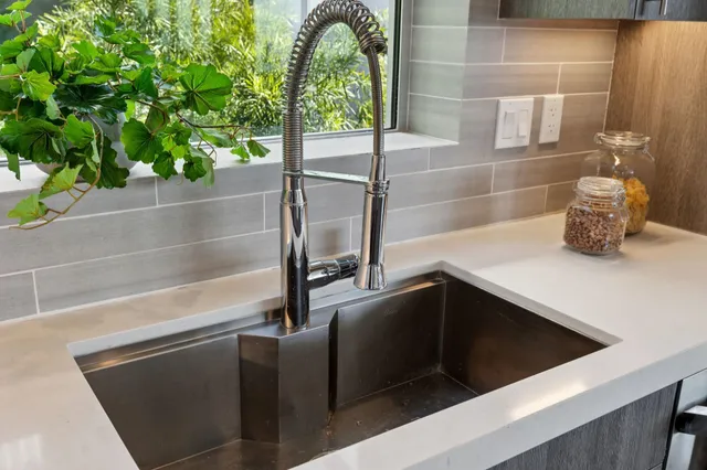 a bedroom with a bed and a potted plant