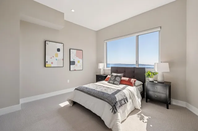 a bedroom with a bed and a chair