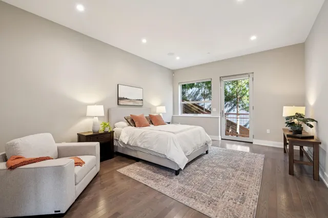 a bedroom with a bed lamp and a potted plant