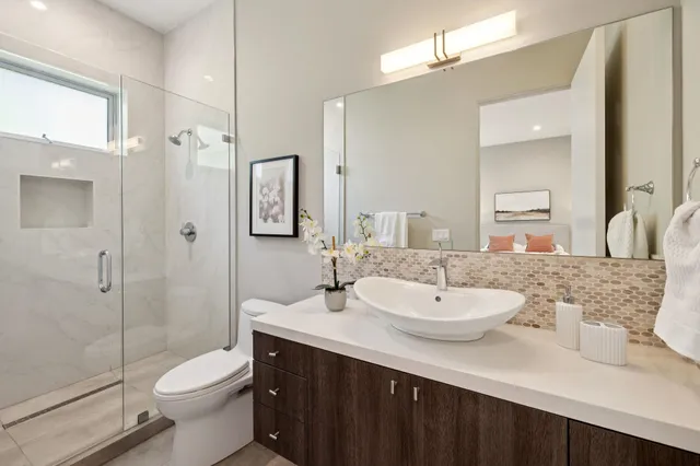 a bedroom with a bed and a mirror