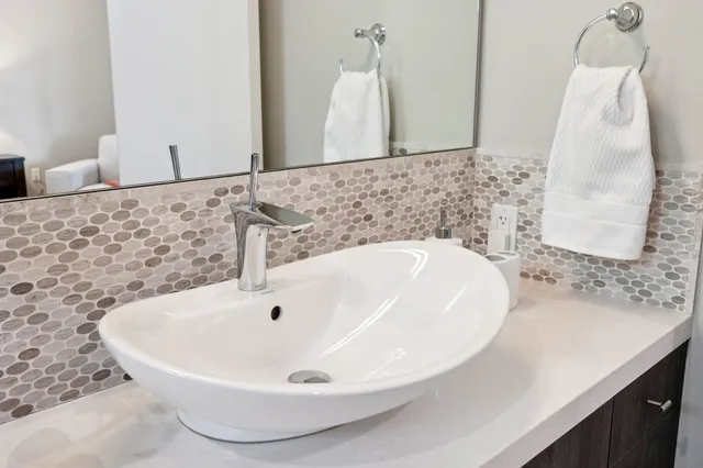 a bathroom with a bathtub a sink and a mirror