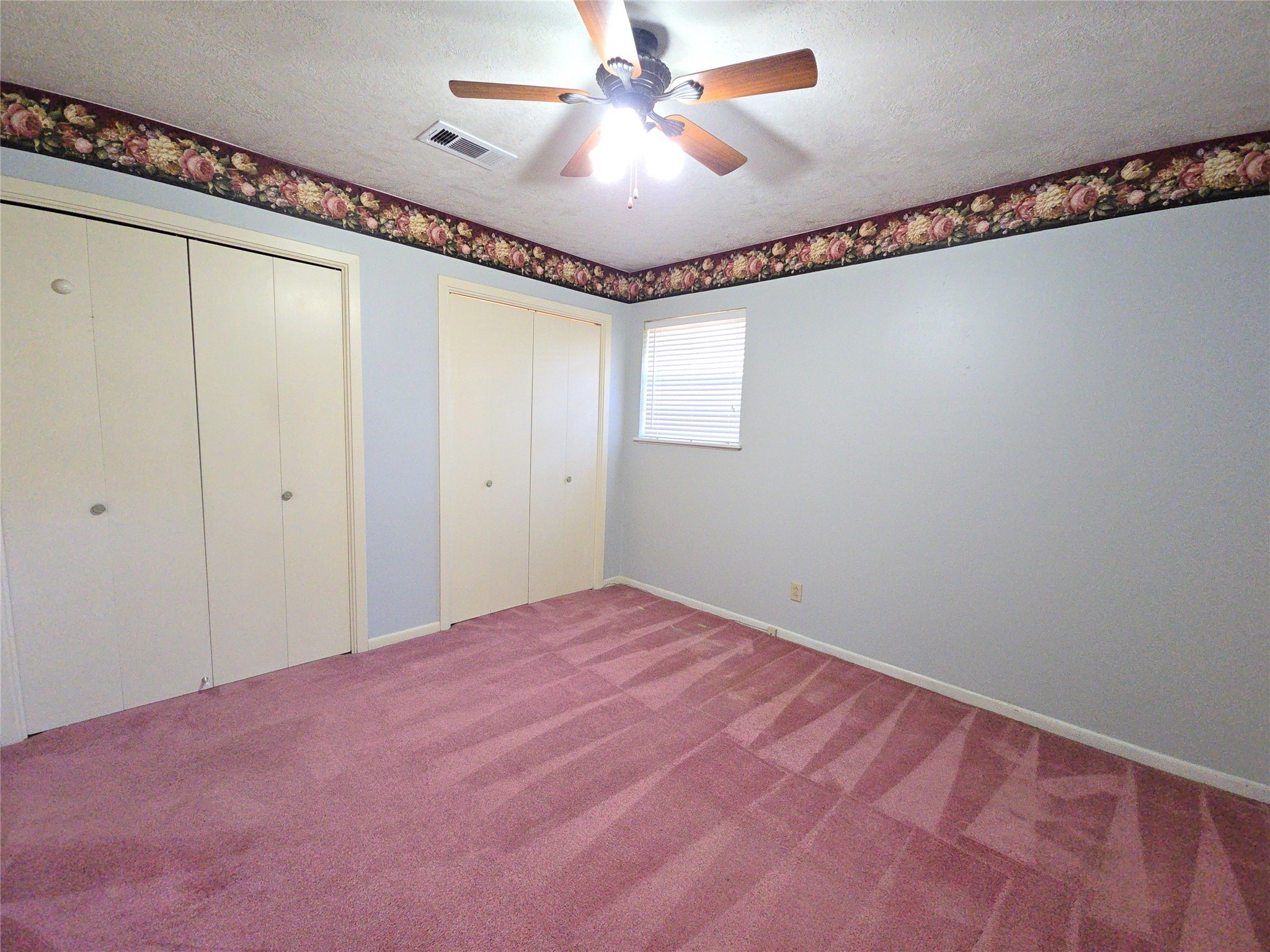 1206 Crescent Boulevard Cleveland, TX 77327 - Photo 18 of 33 a view of a big room with carpet and a chandelier fan