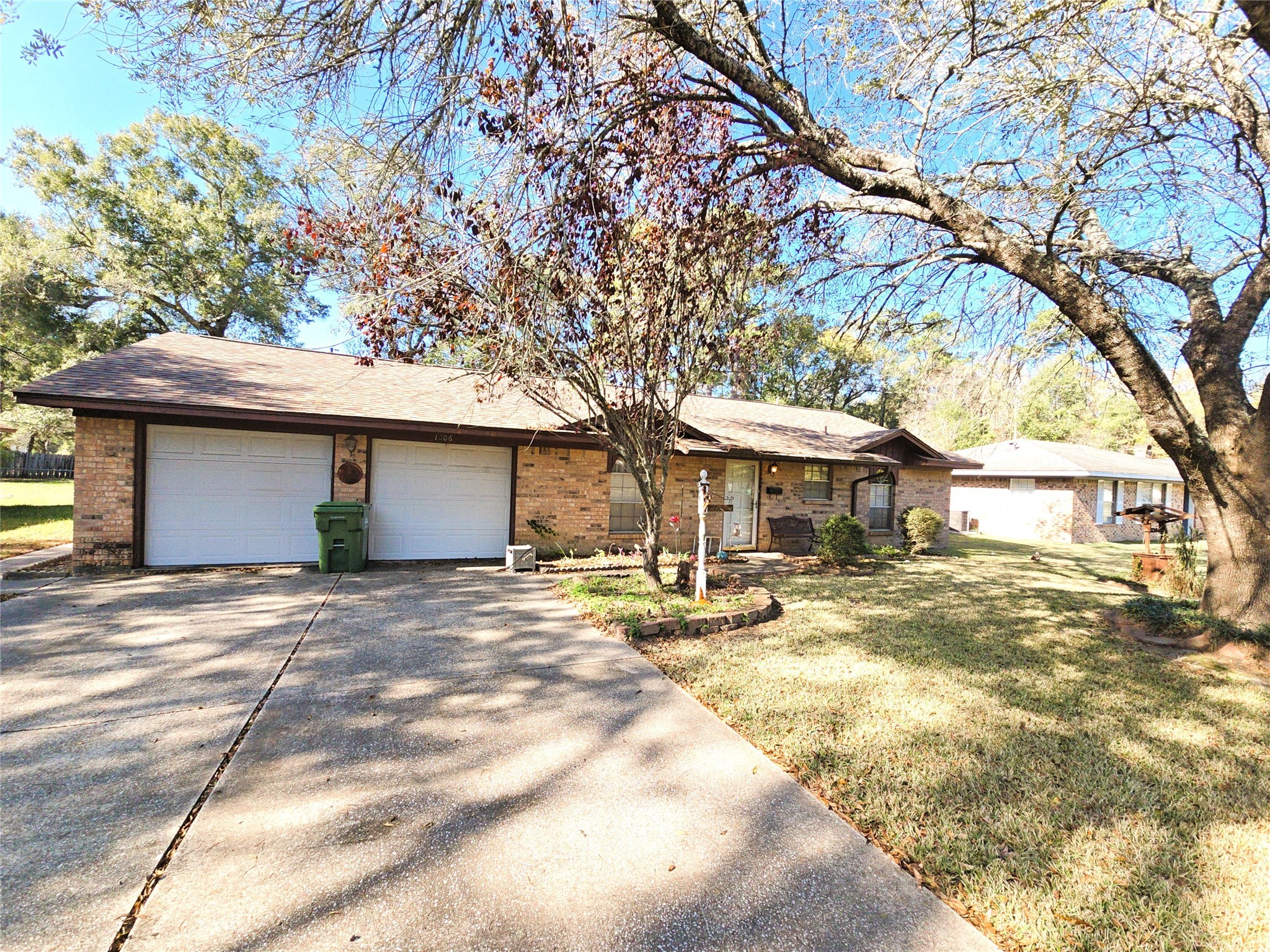 1206 Crescent Boulevard Cleveland, TX 77327 - Photo 31 of 33 a front view of a house with a yard and garage