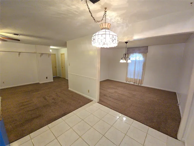 a view of a chandelier and wooden floor in a room