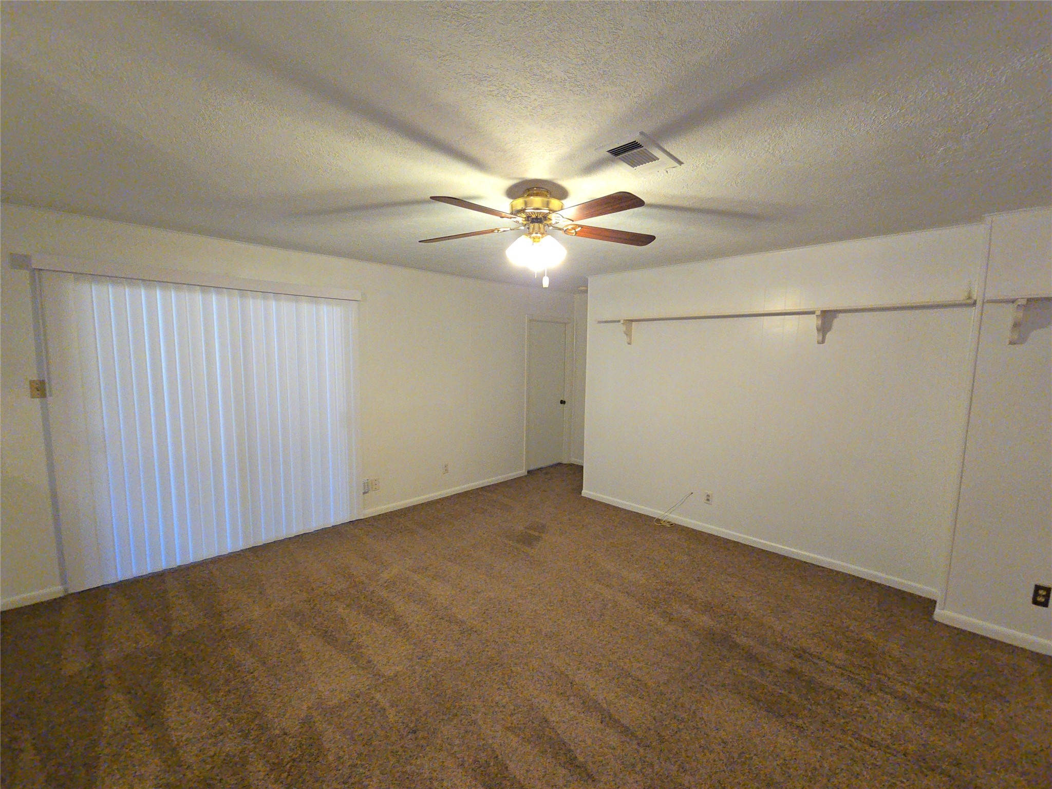 1206 Crescent Boulevard Cleveland, TX 77327 - Photo 9 of 33 an empty room with windows and fan