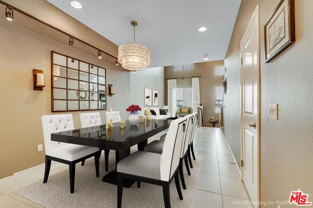a view of a dining room with furniture and a chandelier