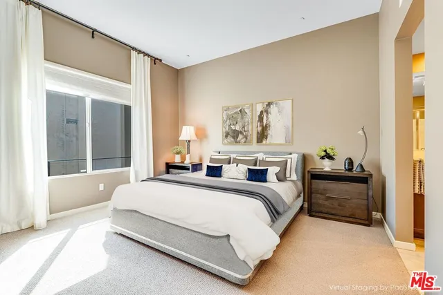 a bedroom with a bed and a large window