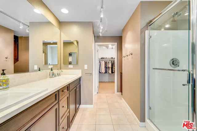 a bathroom with a granite countertop sink mirror and shower