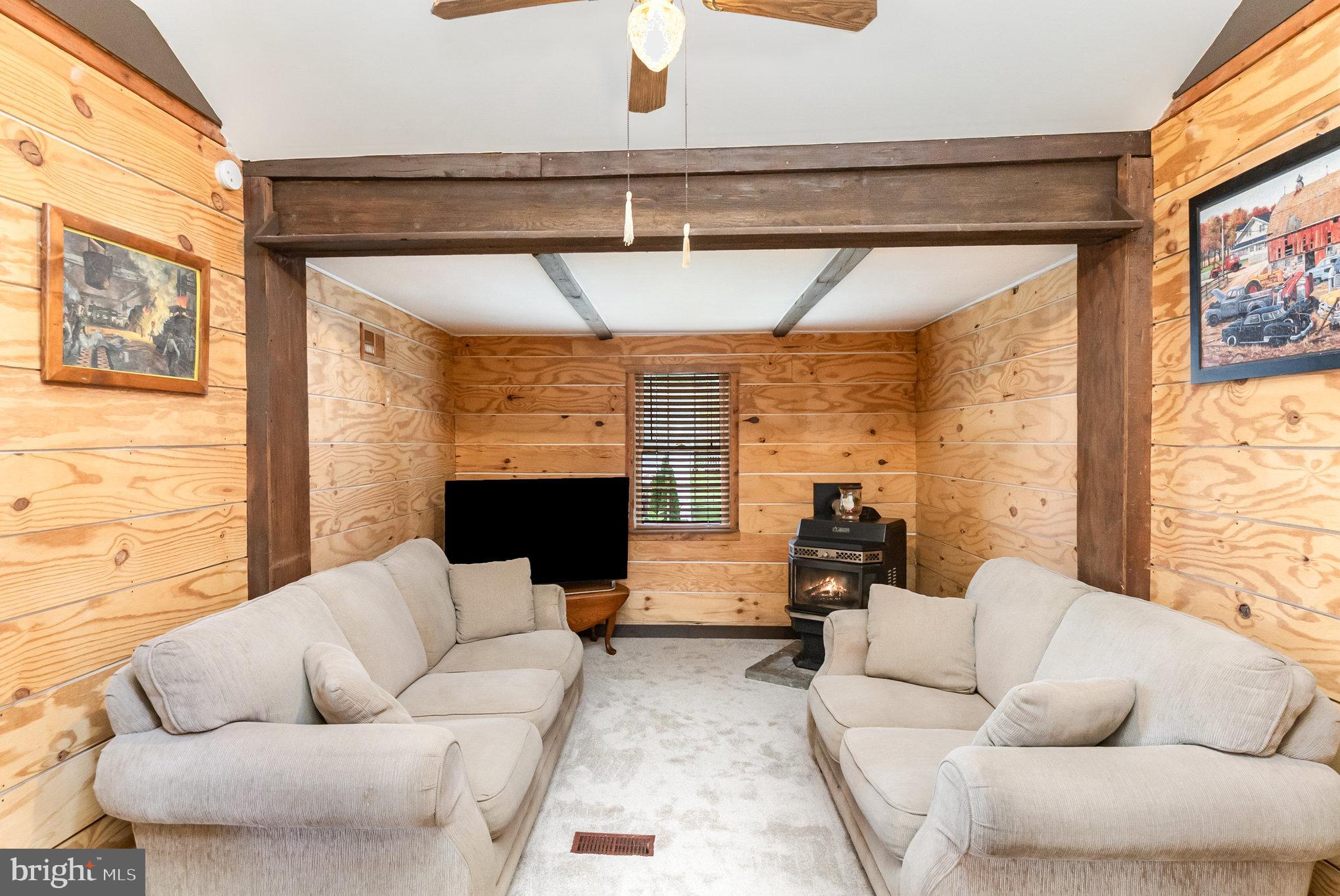 66 Spready Oak Road Rising Sun, MD 21911 - Photo 11 of 30 a living room with furniture a flat screen tv and a large window