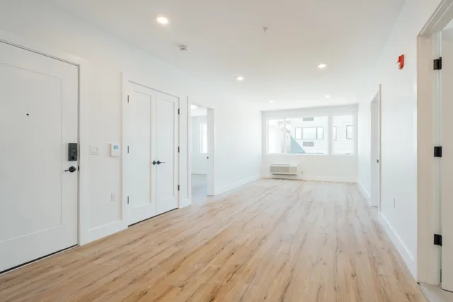 a view of an empty room and wooden floor