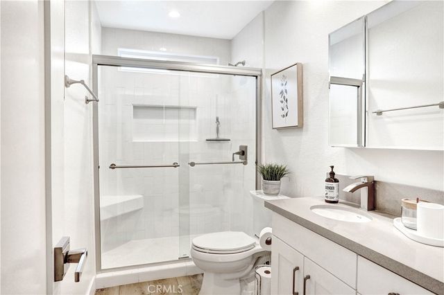 a bathroom with a sink a toilet and a shower